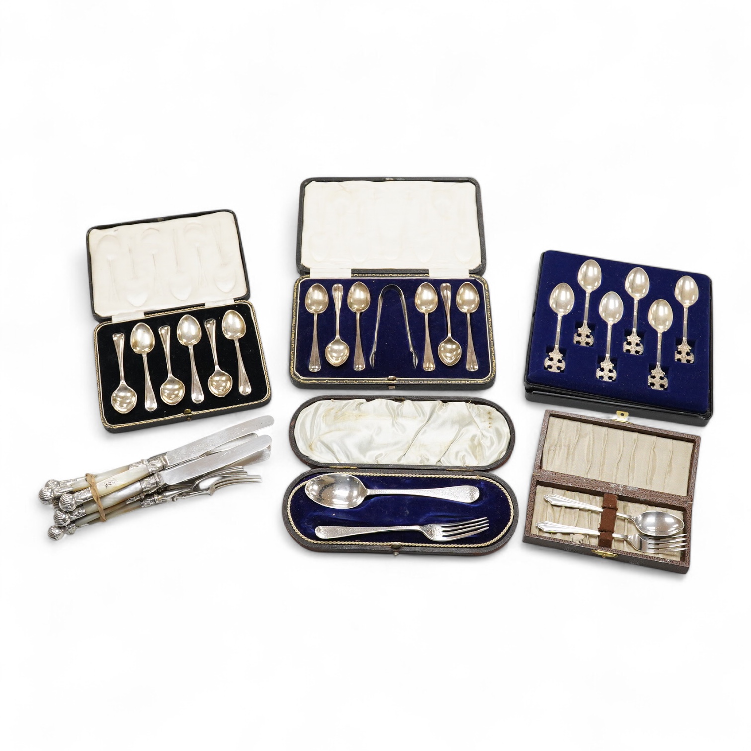 A cased Edwardian silver christening pair by Goldsmiths and Silversmiths Co Ltd, London, 1905, two cased sets of six silver teaspoons, one with a pair of sugar tongs, one other cased silver christening pair, a cased set